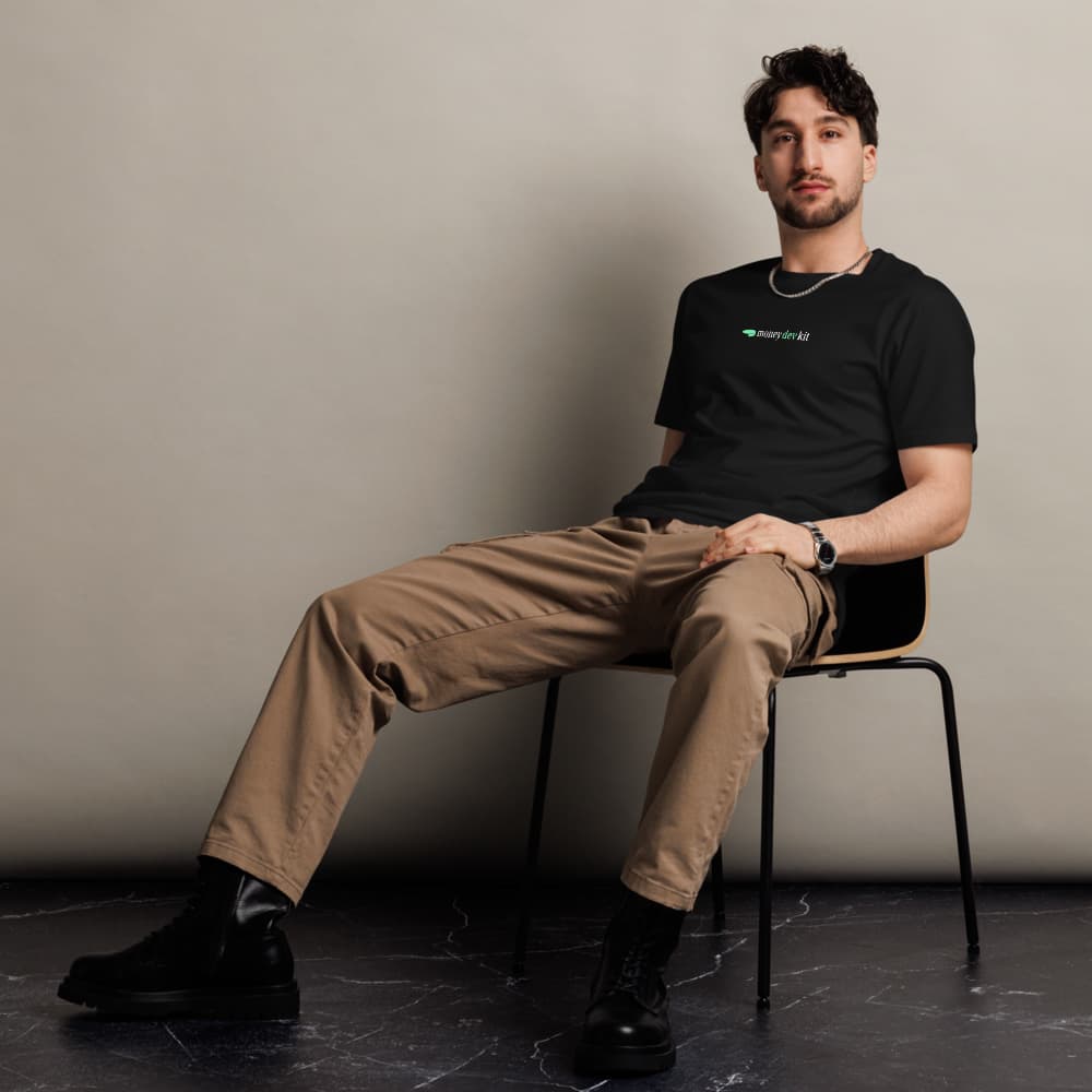 A man wearing the black moneydevkit tee, front logo visible